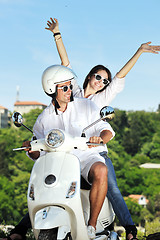 Image showing Portrait of happy young love couple on scooter enjoying summer t