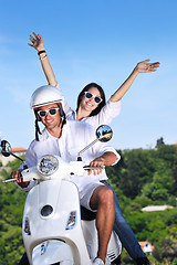 Image showing Portrait of happy young love couple on scooter enjoying summer t