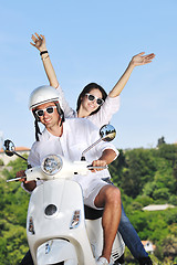 Image showing Portrait of happy young love couple on scooter enjoying summer t