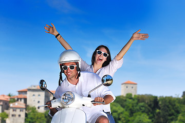 Image showing Portrait of happy young love couple on scooter enjoying summer t