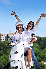 Image showing Portrait of happy young love couple on scooter enjoying summer t