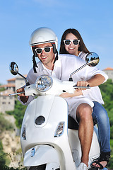 Image showing Portrait of happy young love couple on scooter enjoying summer t