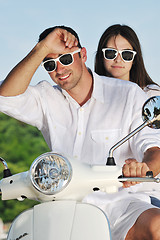 Image showing Portrait of happy young love couple on scooter enjoying summer t