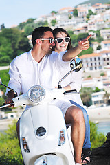 Image showing Portrait of happy young love couple on scooter enjoying summer t