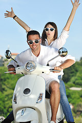 Image showing Portrait of happy young love couple on scooter enjoying summer t