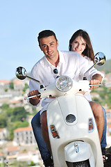 Image showing Portrait of happy young love couple on scooter enjoying summer t