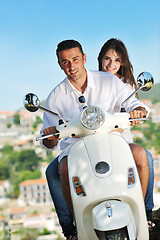 Image showing Portrait of happy young love couple on scooter enjoying summer t