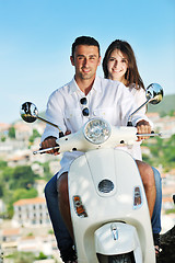 Image showing Portrait of happy young love couple on scooter enjoying summer t