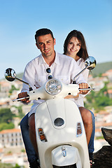 Image showing Portrait of happy young love couple on scooter enjoying summer t