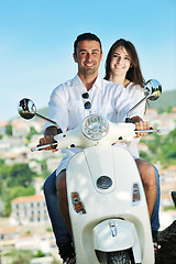 Image showing Portrait of happy young love couple on scooter enjoying summer t