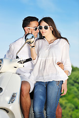 Image showing Portrait of happy young love couple on scooter enjoying summer t