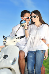 Image showing Portrait of happy young love couple on scooter enjoying summer t