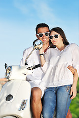 Image showing Portrait of happy young love couple on scooter enjoying summer t