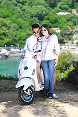 Image showing Portrait of happy young love couple on scooter enjoying summer t