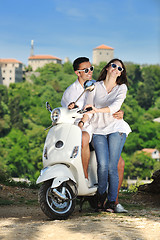 Image showing Portrait of happy young love couple on scooter enjoying summer t