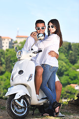 Image showing Portrait of happy young love couple on scooter enjoying summer t