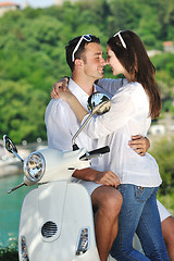 Image showing Portrait of happy young love couple on scooter enjoying summer t