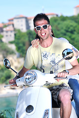 Image showing Portrait of happy young love couple on scooter enjoying summer t