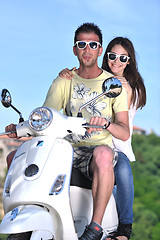 Image showing Portrait of happy young love couple on scooter enjoying summer t