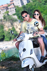 Image showing Portrait of happy young love couple on scooter enjoying summer t