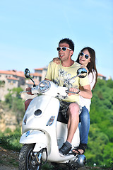 Image showing Portrait of happy young love couple on scooter enjoying summer t