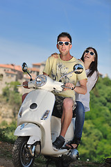 Image showing Portrait of happy young love couple on scooter enjoying summer t