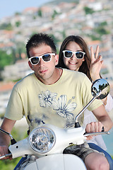 Image showing Portrait of happy young love couple on scooter enjoying summer t