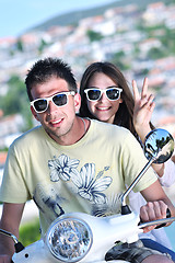 Image showing Portrait of happy young love couple on scooter enjoying summer t