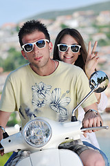 Image showing Portrait of happy young love couple on scooter enjoying summer t