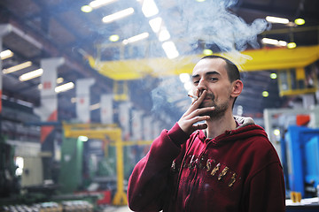 Image showing industry worker smoke cigarette