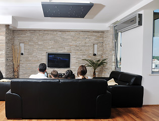 Image showing family wathching flat tv at modern home indoor