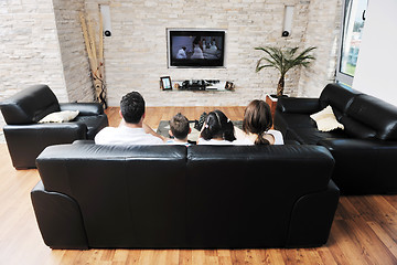 Image showing family wathching flat tv at modern home indoor