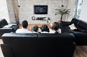 Image showing family wathching flat tv at modern home indoor