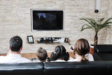 Image showing family wathching flat tv at modern home indoor