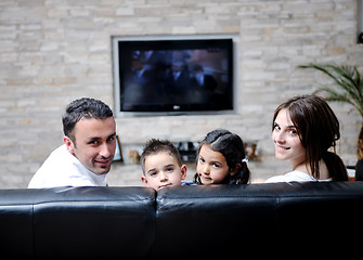 Image showing family wathching flat tv at modern home indoor