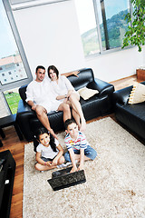 Image showing happy young family have fun and working on laptop at home