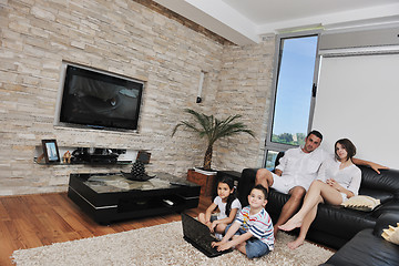 Image showing happy young family have fun and working on laptop at home