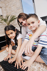 Image showing happy young family have fun and working on laptop at home