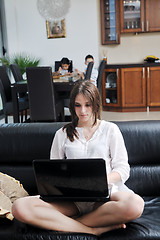 Image showing happy young family have fun and working on laptop at home