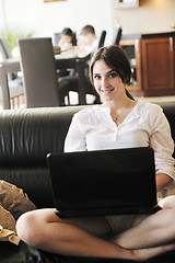 Image showing happy young family have fun and working on laptop at home