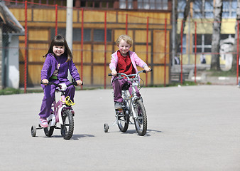 Image showing happy childrens group learning to drive bicycle