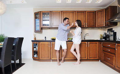 Image showing happy young couple have fun in modern kitchen