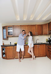 Image showing happy young couple have fun in modern kitchen