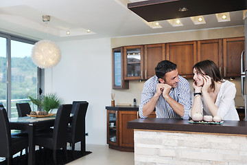 Image showing happy young couple have fun in modern kitchen