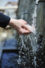 Image showing fresh mountain water falling on hands