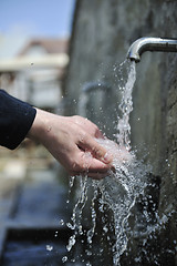 Image showing fresh mountain water falling on hands