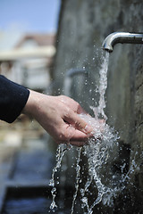 Image showing fresh mountain water falling on hands