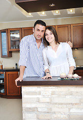 Image showing happy young couple have fun in modern kitchen