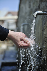 Image showing fresh mountain water falling on hands