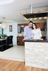 Image showing happy young couple have fun in modern kitchen